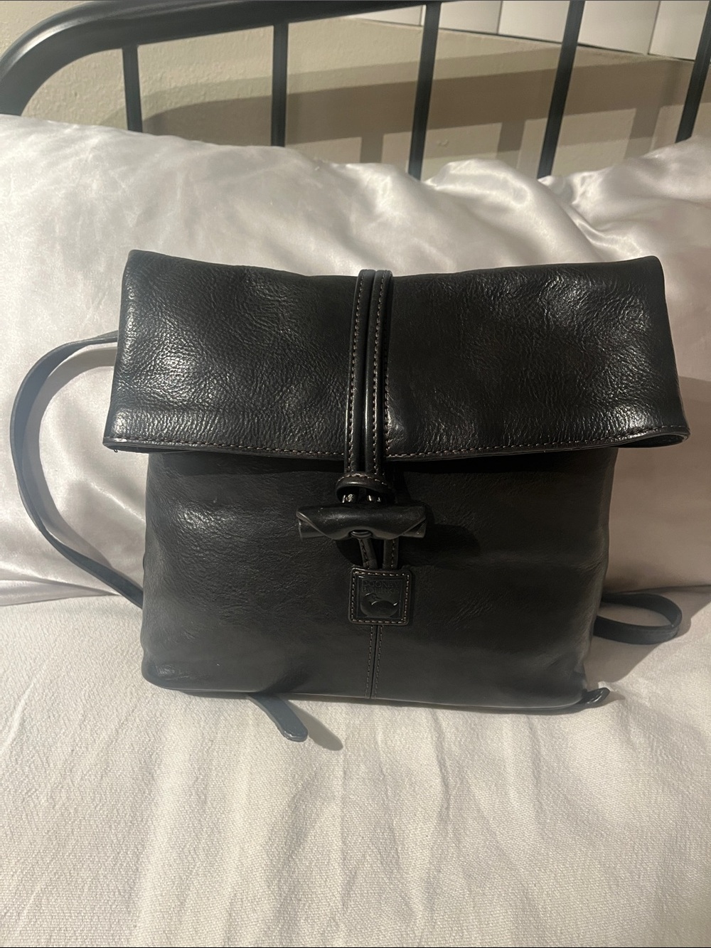 Dooney & Burke black leather backpack with red lining. High quality & timeless